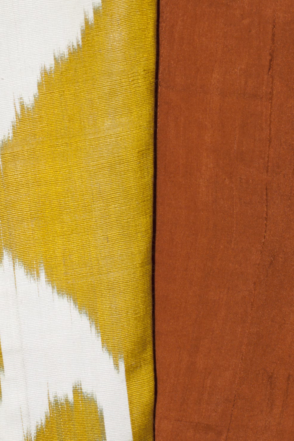 arta silk coat fabric close-up — handwoven ikat weaving detail by Aleksandra Viktor master artisans in Uzbekistan