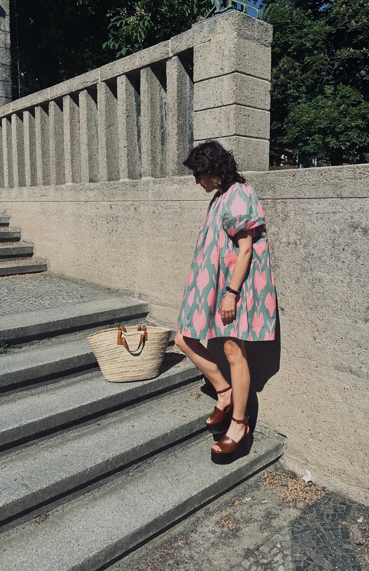 Cora luxury ikat cotton short dress worn front — model wearing Aleksandra Viktor handwoven cotton dress in vibrant ikat pattern