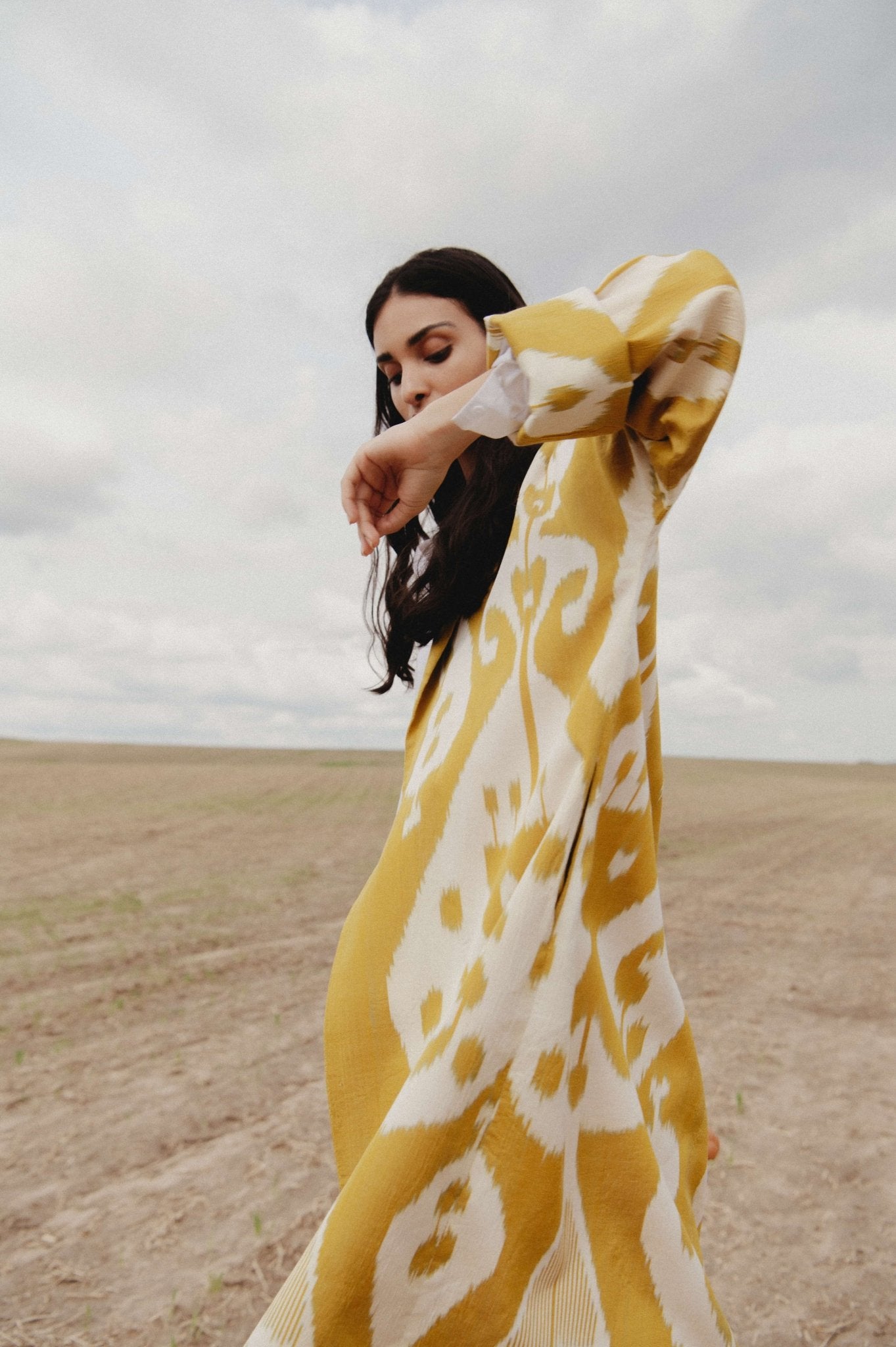 Marta silk coat worn side — model wearing Aleksandra Viktor exclusively tailored luxury ikat silk coat