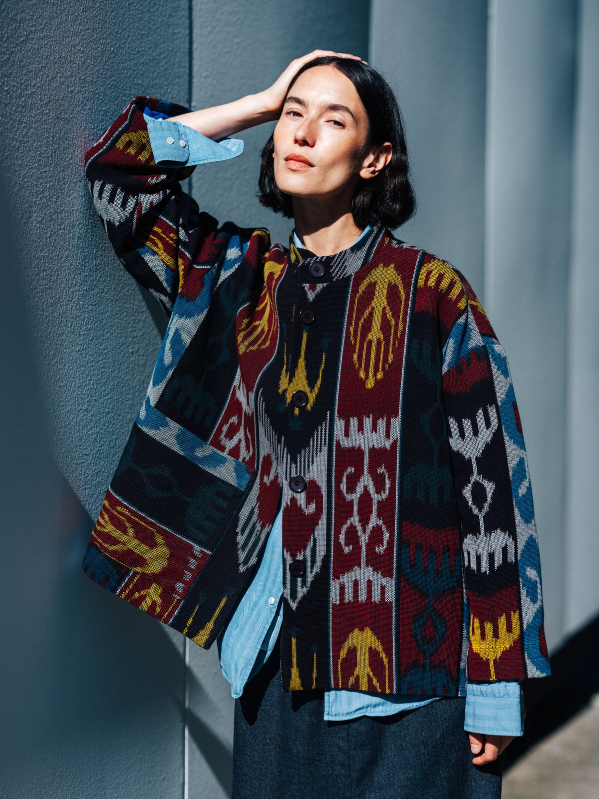 Jana ikat cotton jacket worn by model — boxy handwoven ikat jacket in burgundy, black, blue and mustard with stand collar and buttons, Aleksandra Viktor Berlin