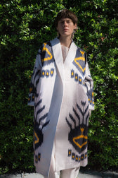 Tatjana luxury ikat silk coat worn front — model wearing Aleksandra Viktor handwoven silk coat in rich ikat pattern