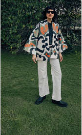 Sandra luxury ikat silk cotton jacket worn front — model wearing Aleksandra Viktor handwoven short coat in earthy ikat pattern