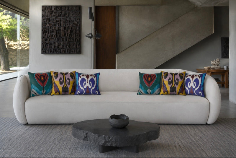 Ikat silk pillow cases styled on a white sofa in a modern living room