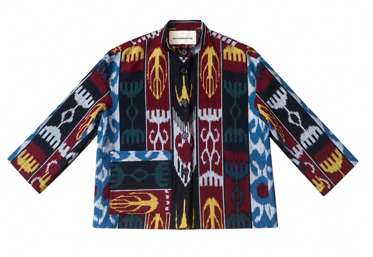 Jana ikat cotton jacket flat lay — handwoven ikat in burgundy, black, blue and mustard with stand collar, buttons and patch pocket