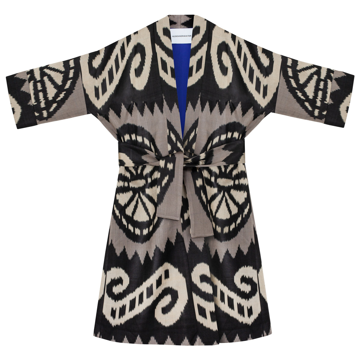 Laura ikat coat flat lay with belt — black, ecru and grey handwoven ikat with royal blue lining, Aleksandra Viktor