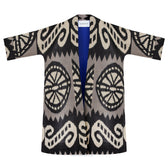 Laura ikat coat flat lay front, open — large ikat rosettes and swirls, royal blue lining