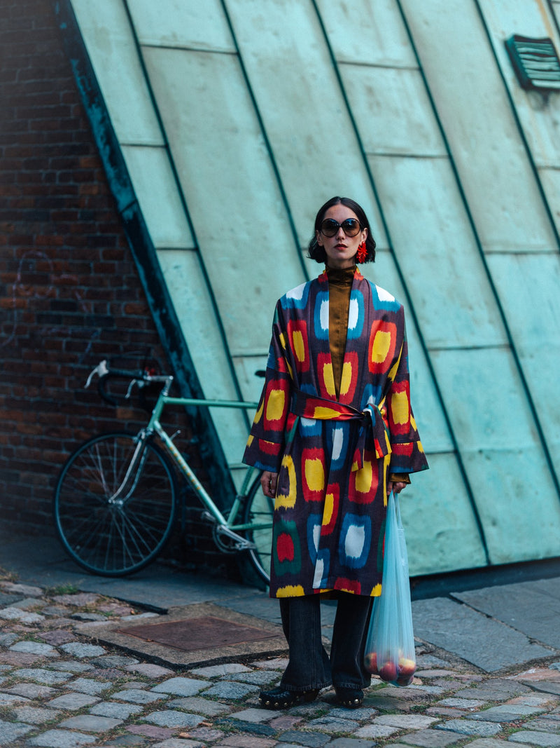 Roberta ikat coat by Aleksandra Viktor — colourful handwoven Uzbek ikat in yellow, red, blue and white on aubergine, belted kimono-style coat